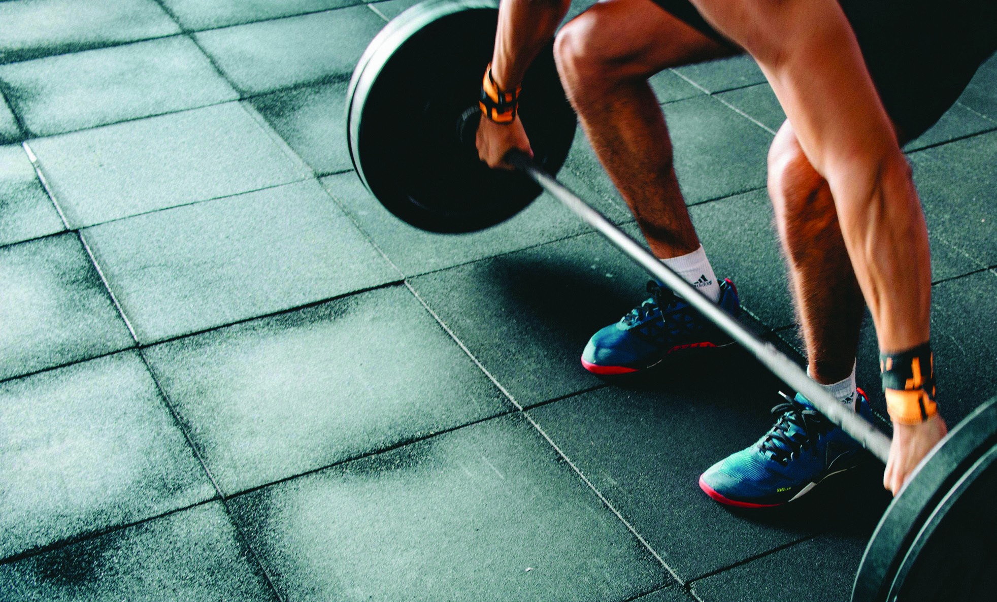A person exercising with a dumbbell in a gym