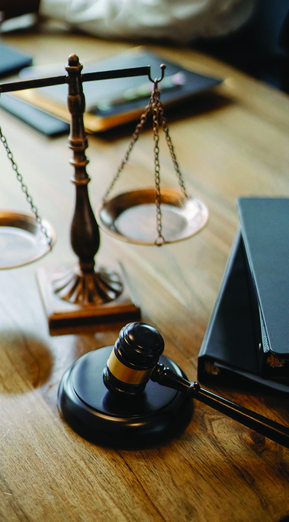 Scales of justice and a gavel on a desk